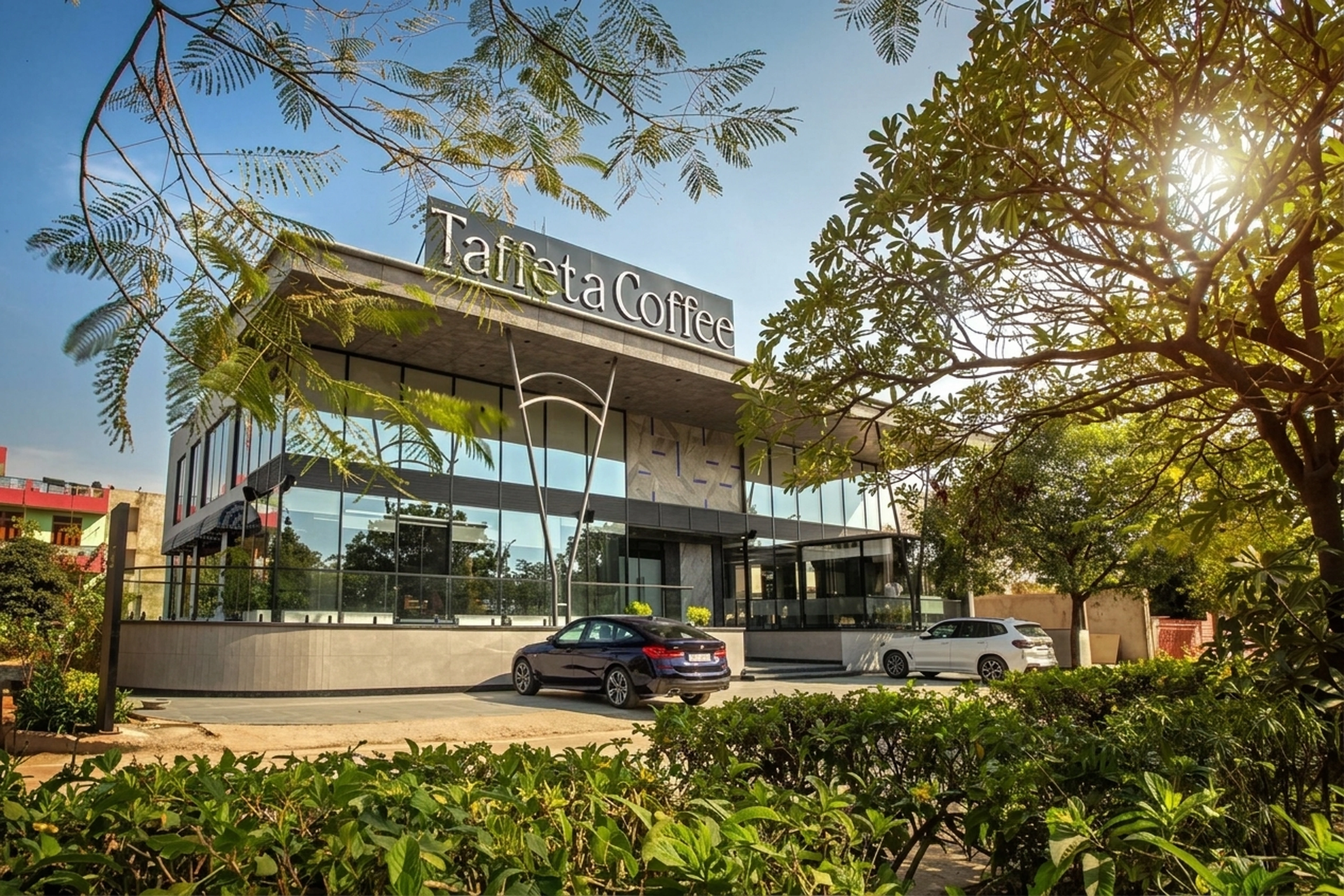 Taffeta Coffee glass facade, golden sunburst and landscaped entrance